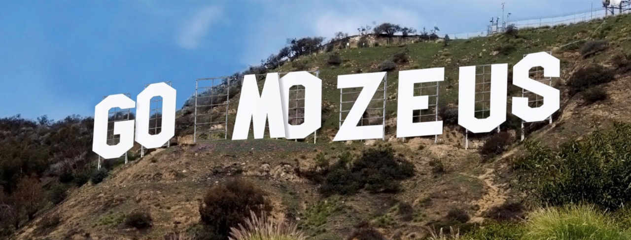giant go mozeus letters on a mountain resembling the hollywood sign.
