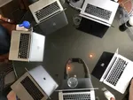 Circle of MacBooks.