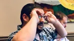 a man adjusting his glasses.