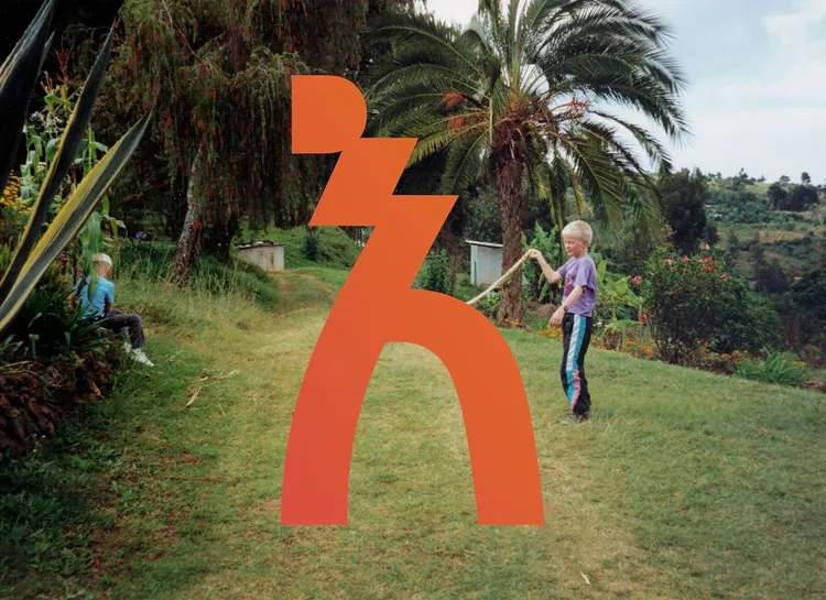 2 kids playing in a tropical garden with an amharic symbol superimposed.
