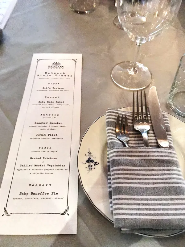plate with cutlery and a menu card on a table.