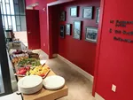breakfast buffet next to a bright red wall.