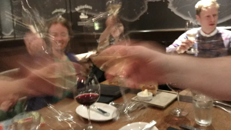 people toasting their glasses.