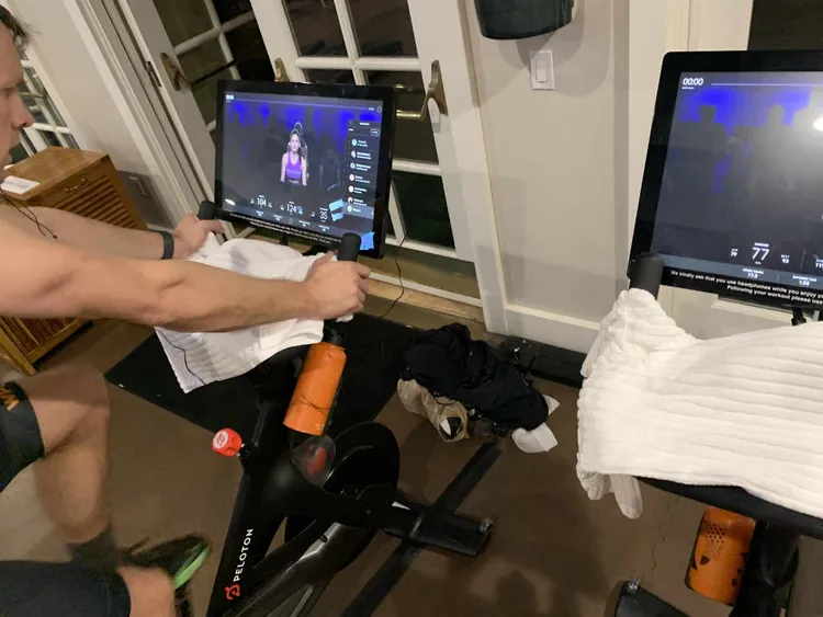guy sweating on a peloton bike in the gym